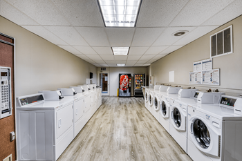 A laundromat with rows of washers and dryers.